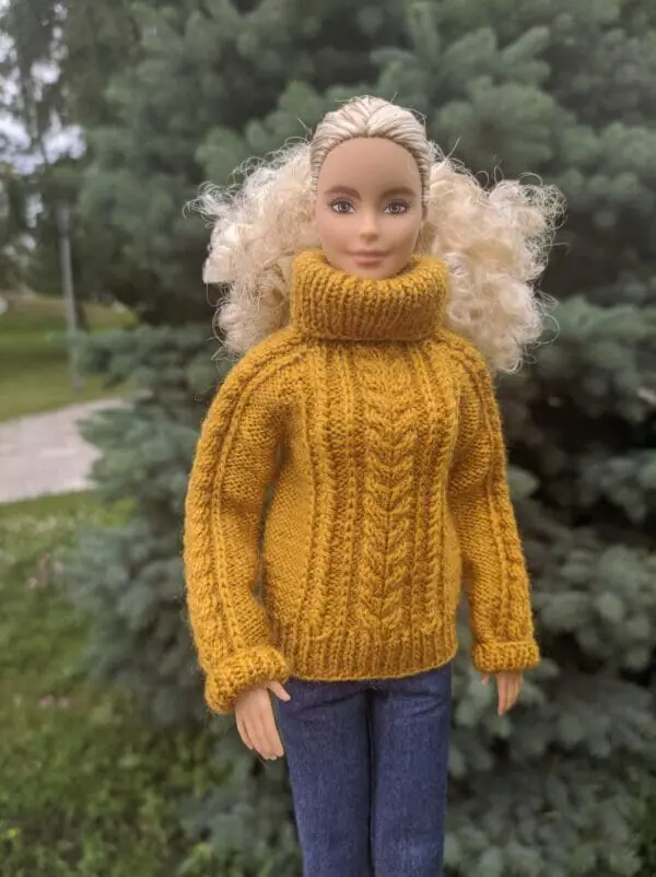 Right side view of Barbie in mustard turtleneck sweater.