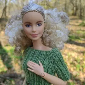 Close-up of Green knit Barbie dress.