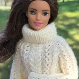 Close-up of Barbie in cream knit sweater