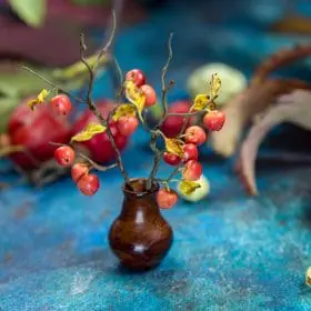 Miniature wild apples on a branch made of polymer clay and air dry clay