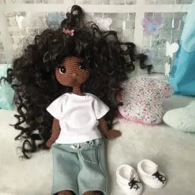 doll sitting in jeans