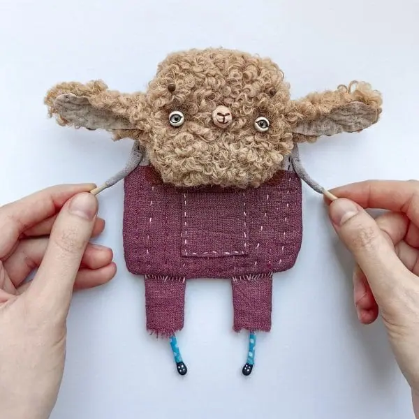 one-of-kind-textile-art-doll-sheep-in-violet-pants-in-hands