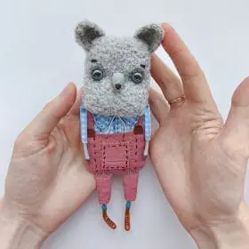 one of kind textile art doll gray wolf in pink pants in hands