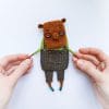 textile art doll capybara in pants in hands