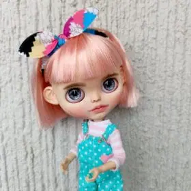 Blythe doll custom with pink hair and slightly open mouth with teeth