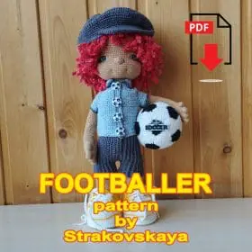 The redheaded soccer player is standing with the ball eng