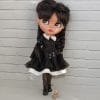 Doll Wednesday, in a black dress