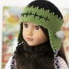 An 18-inch American girl doll in a crocheted Frankenstein hat