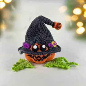 Plush crochet spooky pumpkin amigurumi toy with a witch hat, Halloween handmade pattern.
