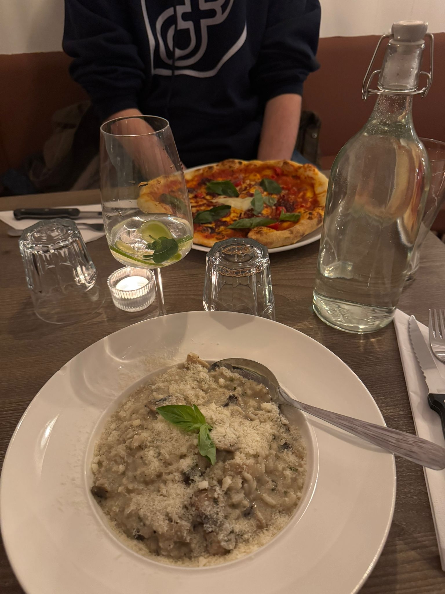 The mushroom risotto with parmesan that my partner had with a martini drink, and on the other side of the table you can see my spicy pizza nduja.