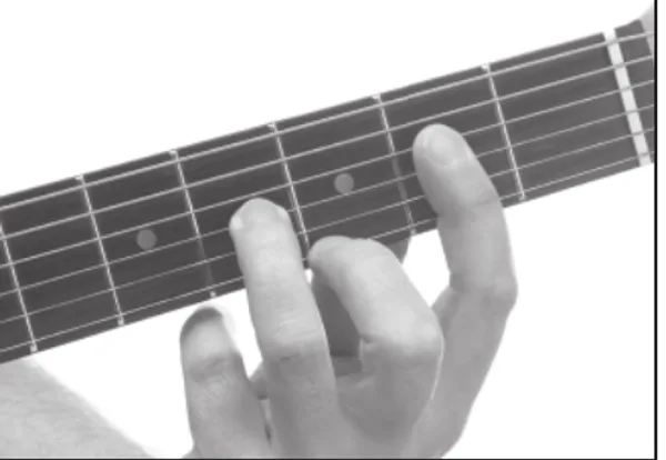 A9 chord — a hand playing it on the guitar fretboard