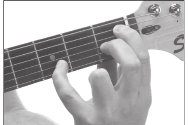 B♭7♭5 chord — a hand playing it on the guitar fretboard