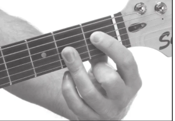 E♭m7♭5 chord — a hand playing it on the guitar fretboard