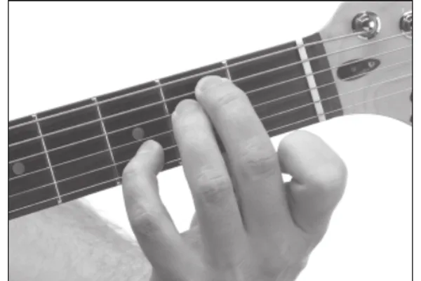 Em7 chord — a hand playing it on the guitar fretboard