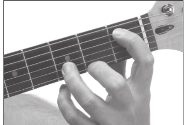Em9♭5 chord — a hand playing it on the guitar fretboard