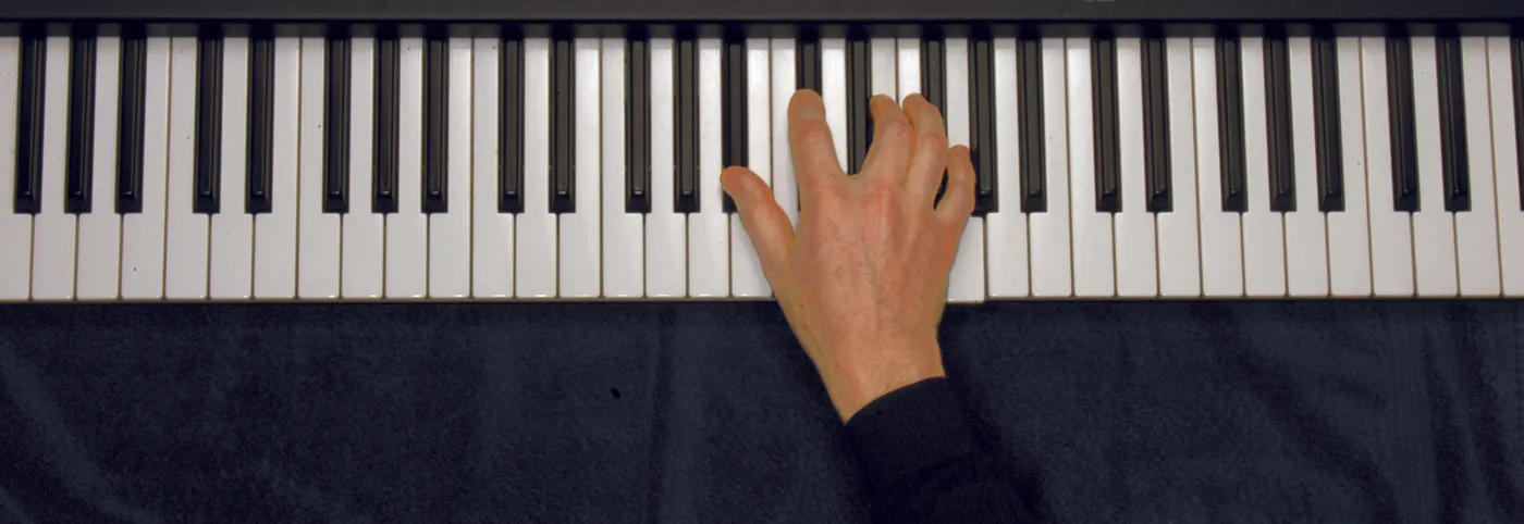 B♭dim7 chord played on a piano — hand position on the keys
