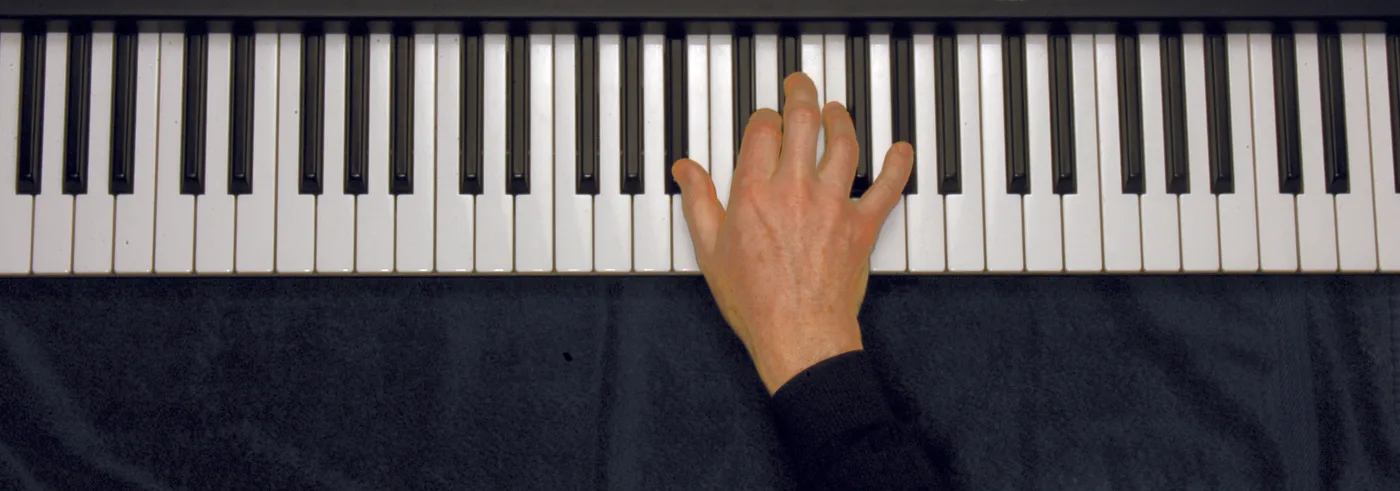B♭7 chord played on a piano — hand position on the keys