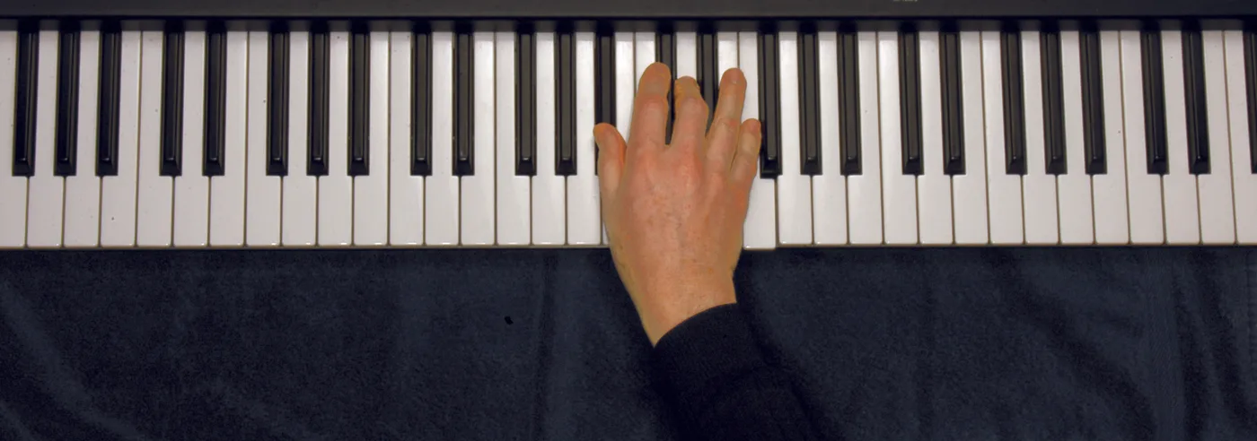 B♭ chord played on a piano — hand position on the keys