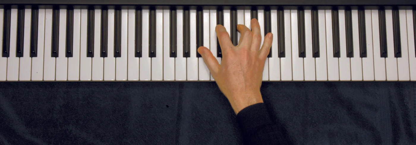B♭m7♭5 chord played on a piano — hand position on the keys