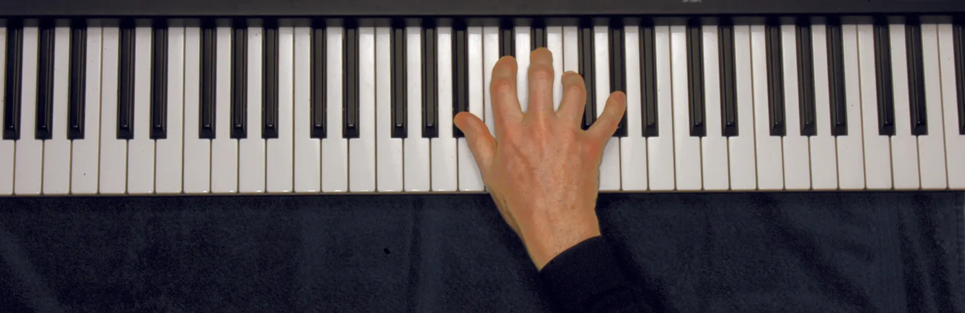 B♭m7 chord played on a piano — hand position on the keys