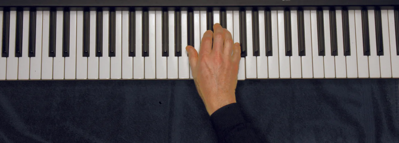 B♭m chord played on a piano — hand position on the keys