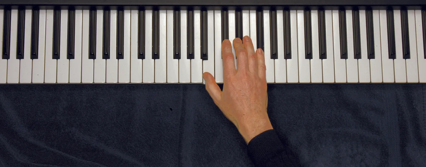 B chord played on a piano — hand position on the keys