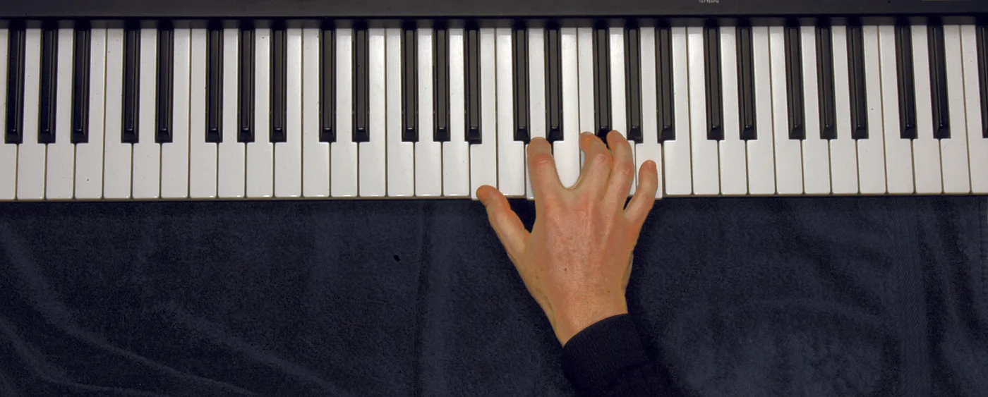 Bm7♭5 chord played on a piano — hand position on the keys