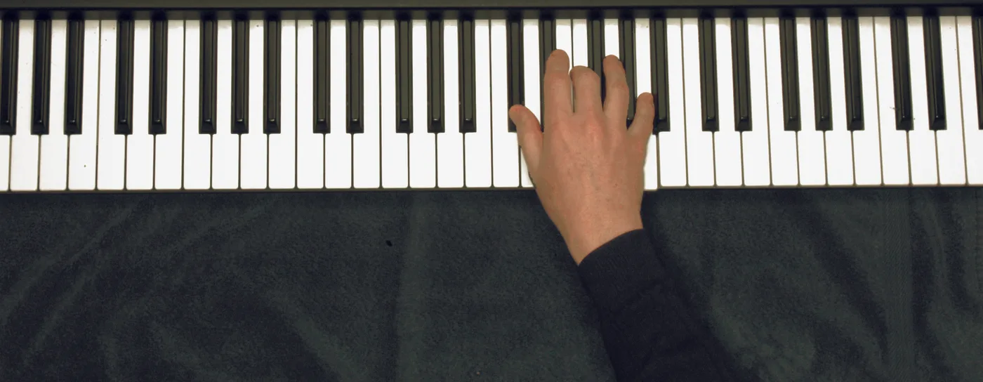 D♭aug chord played on a piano — hand position on the keys