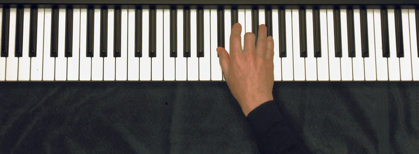 D♭ chord played on a piano — hand position on the keys