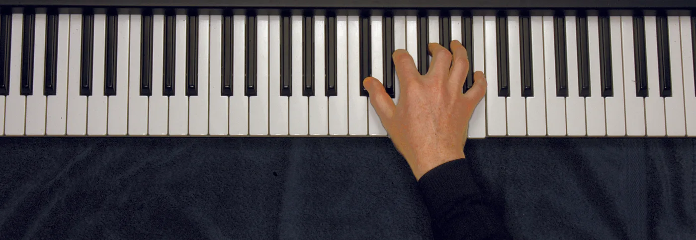 D♭m7♭5 chord played on a piano — hand position on the keys
