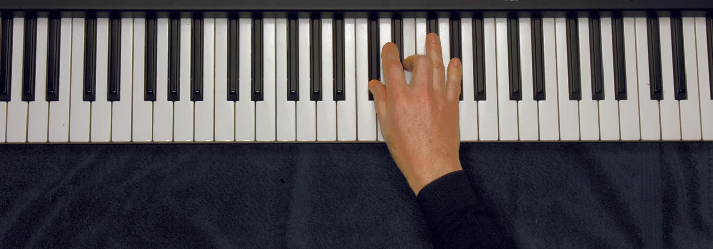 D♭m chord played on a piano — hand position on the keys