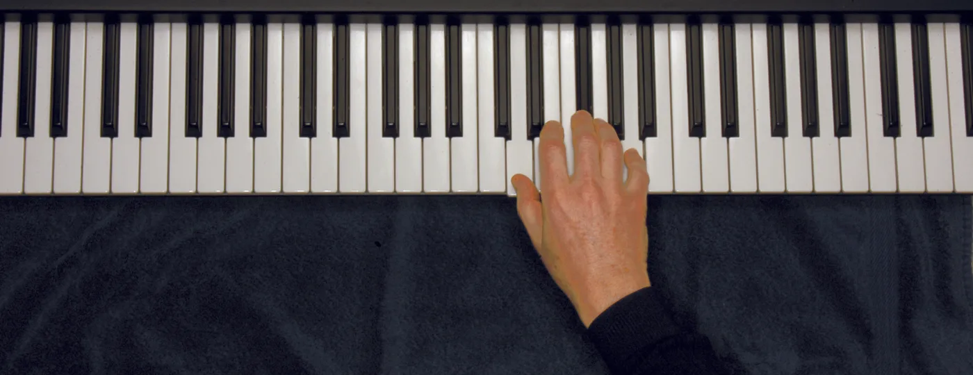 D chord played on a piano — hand position on the keys