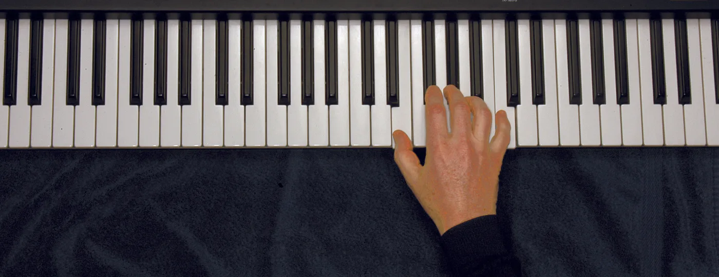 Eaug chord played on a piano — hand position on the keys