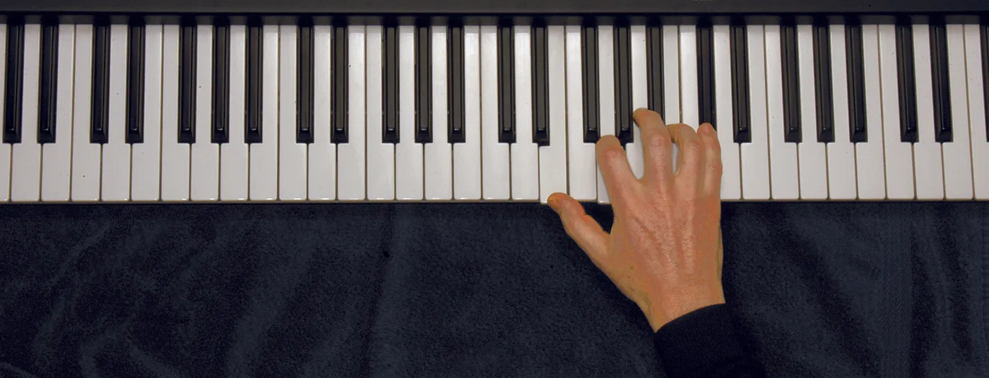 Em7♭5 chord played on a piano — hand position on the keys