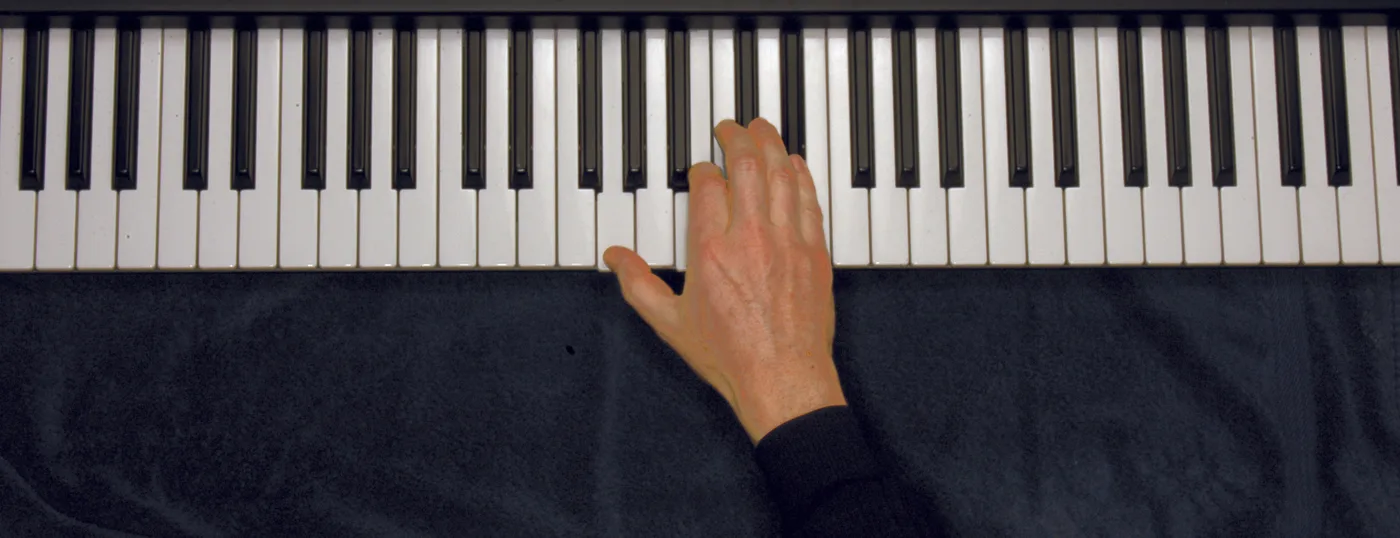 Gaug chord played on a piano — hand position on the keys
