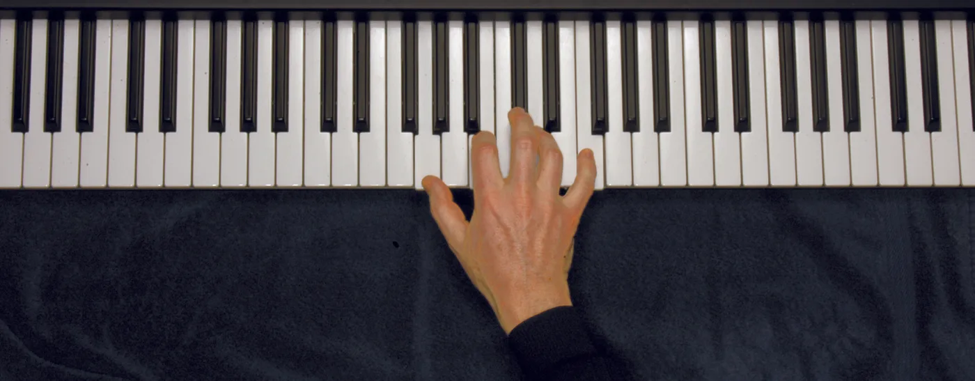 G7 chord played on a piano — hand position on the keys