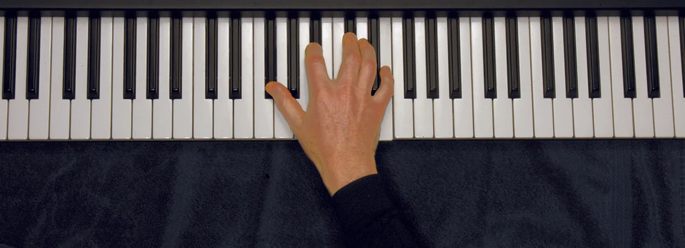 G♭7 chord played on a piano — hand position on the keys