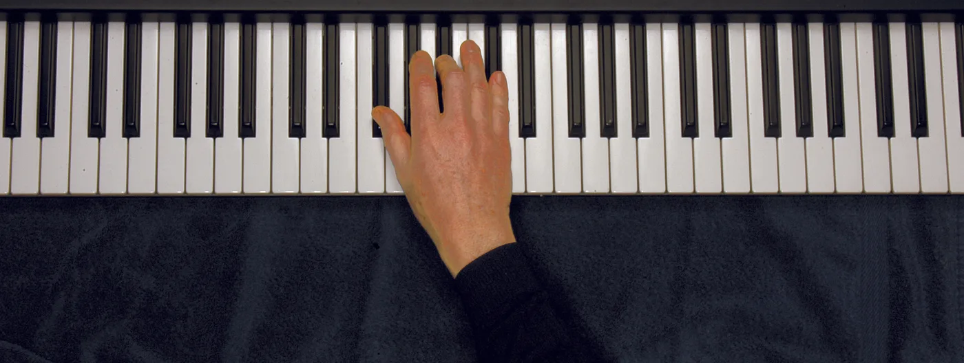 G♭ chord played on a piano — hand position on the keys
