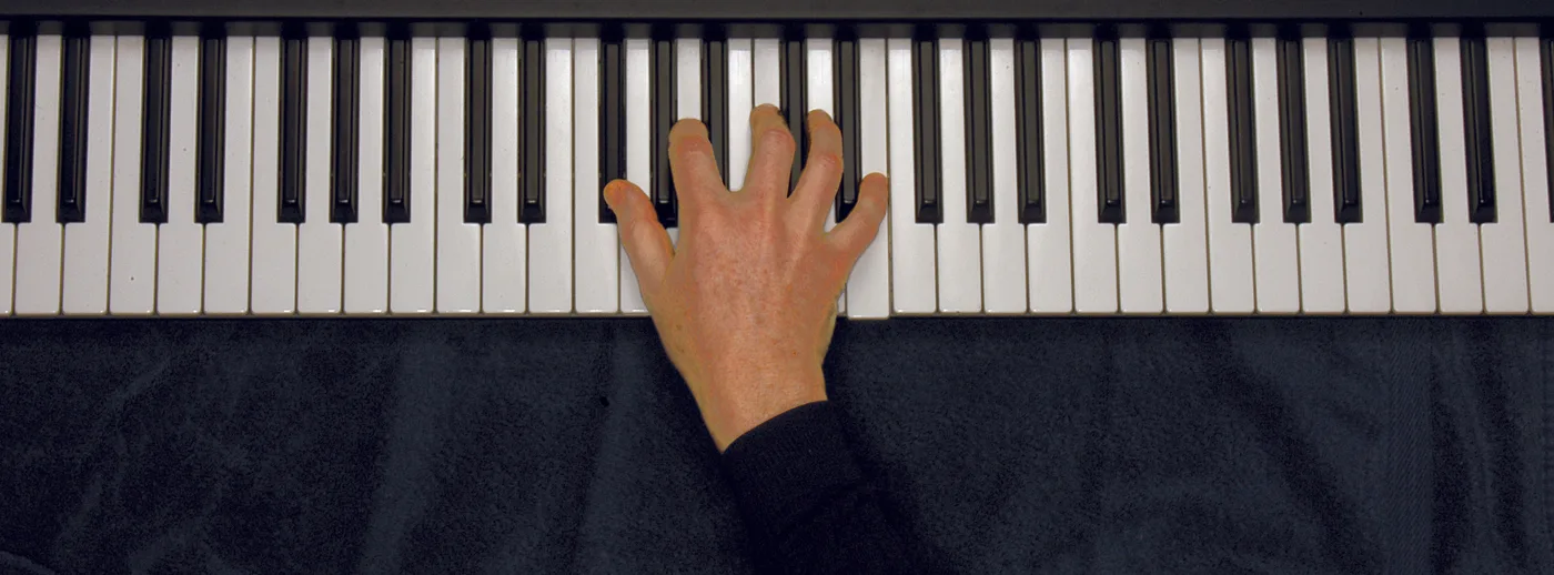G♭m7♭5 chord played on a piano — hand position on the keys