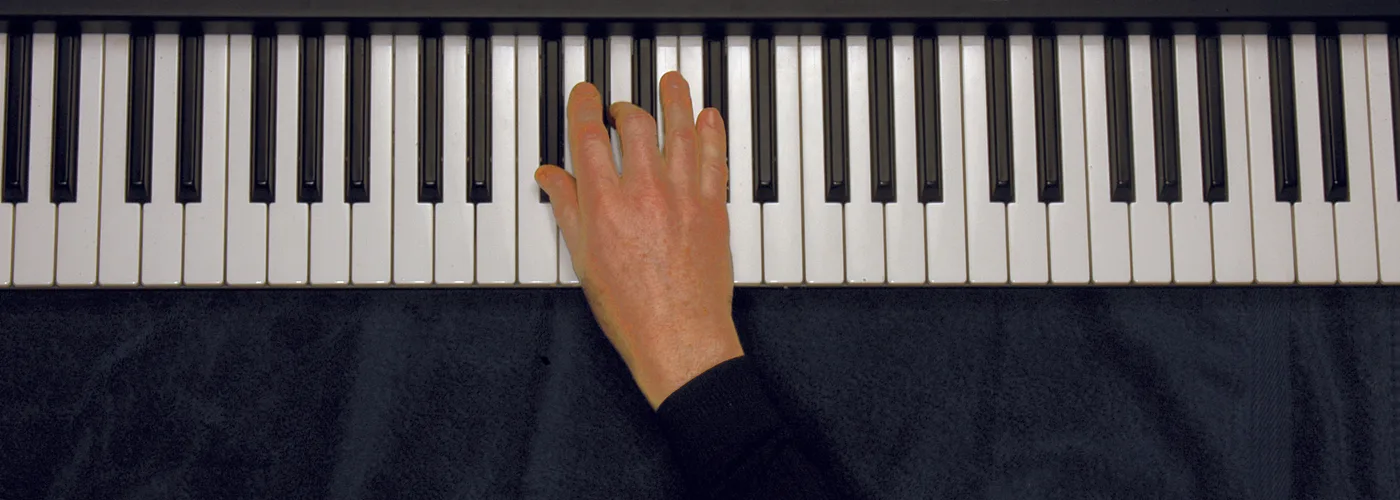 G♭m chord played on a piano — hand position on the keys