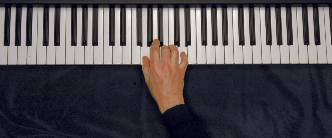 G chord played on a piano — hand position on the keys