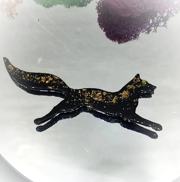 Black fox brooch on mirror