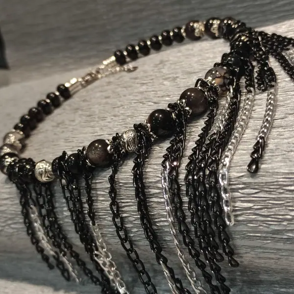 Black Queen necklace on a grey background