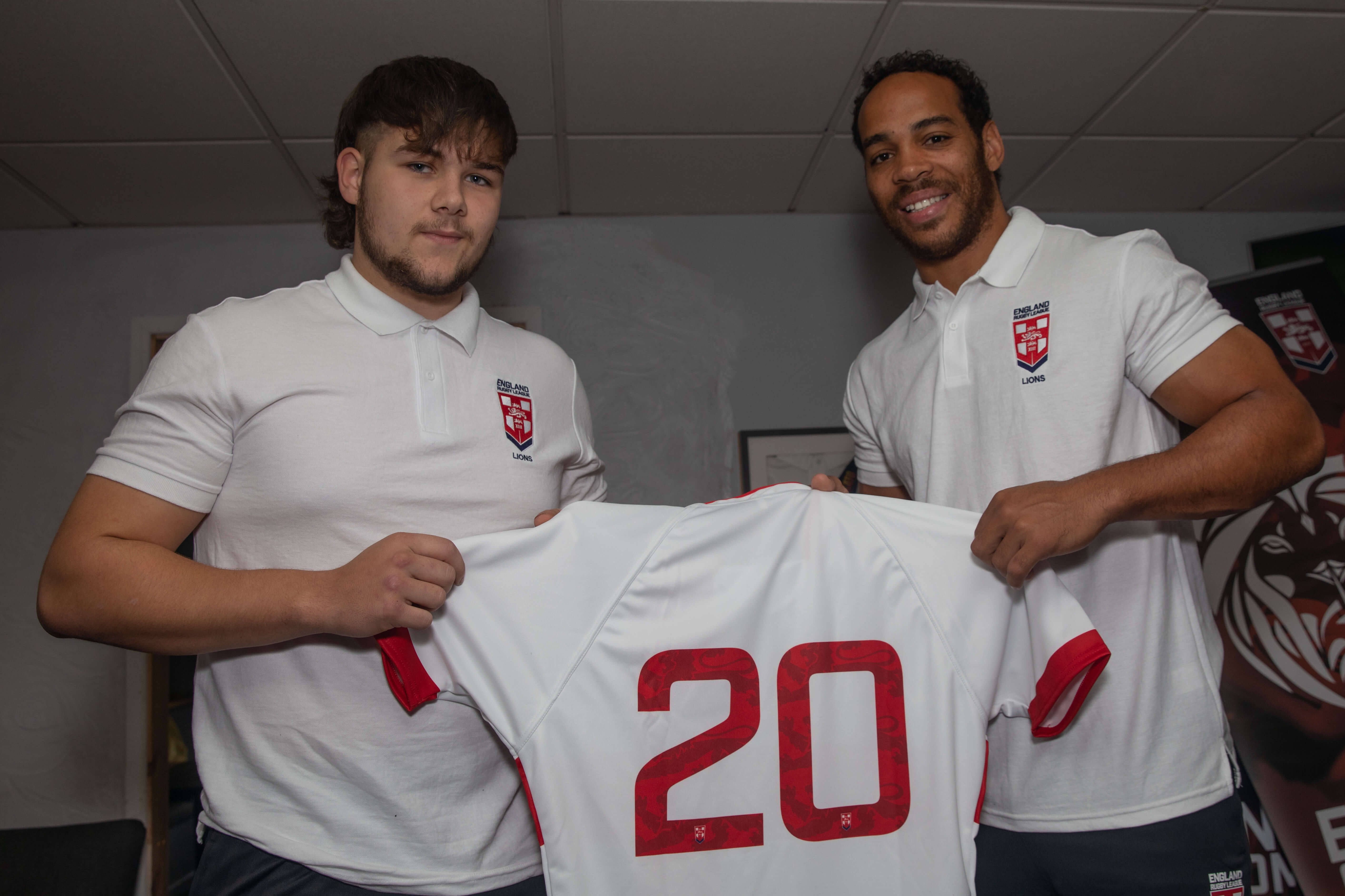 Dylan Turner (left) receives his No 20 England shirt (under-17s) from Huddersfield Giants stalwart and 300-plus games centre Leroy Cudjoe.