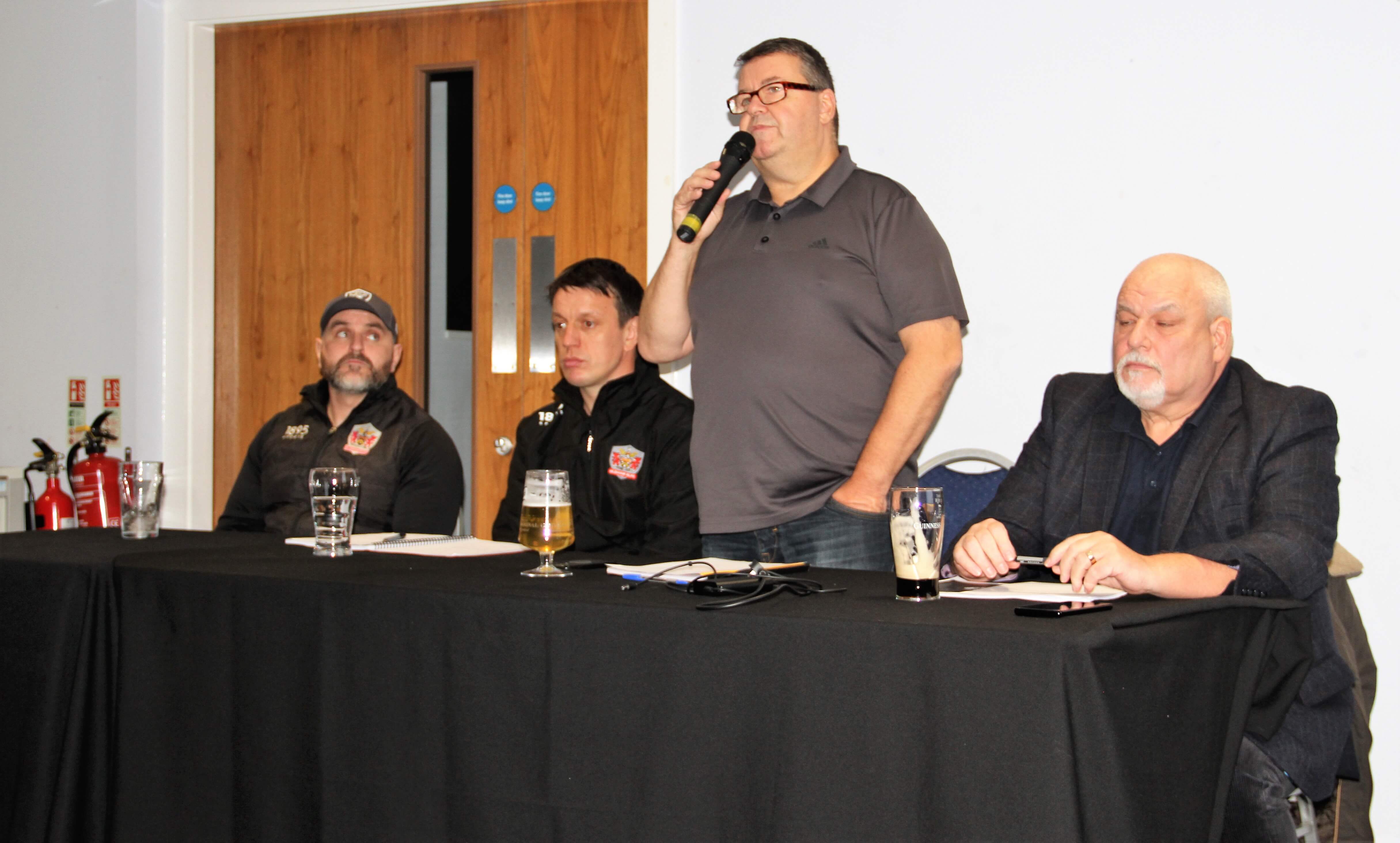 Chris Hamilton on the mic, flanked by John Roddy (to his left) and Stuart Littler and Brendan Sheridan to his right