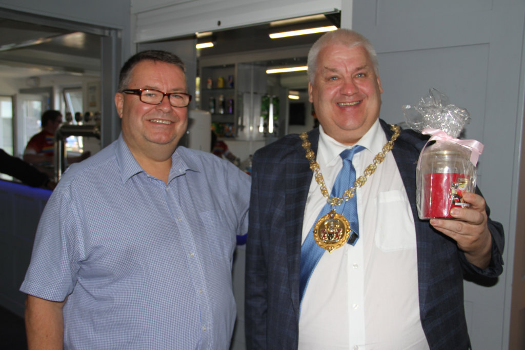 Pictured separately is the Mayor&rsquo;s consort receiving a raffle prize from club chairman Chris Hamilton in the hospitality suite post-game.
