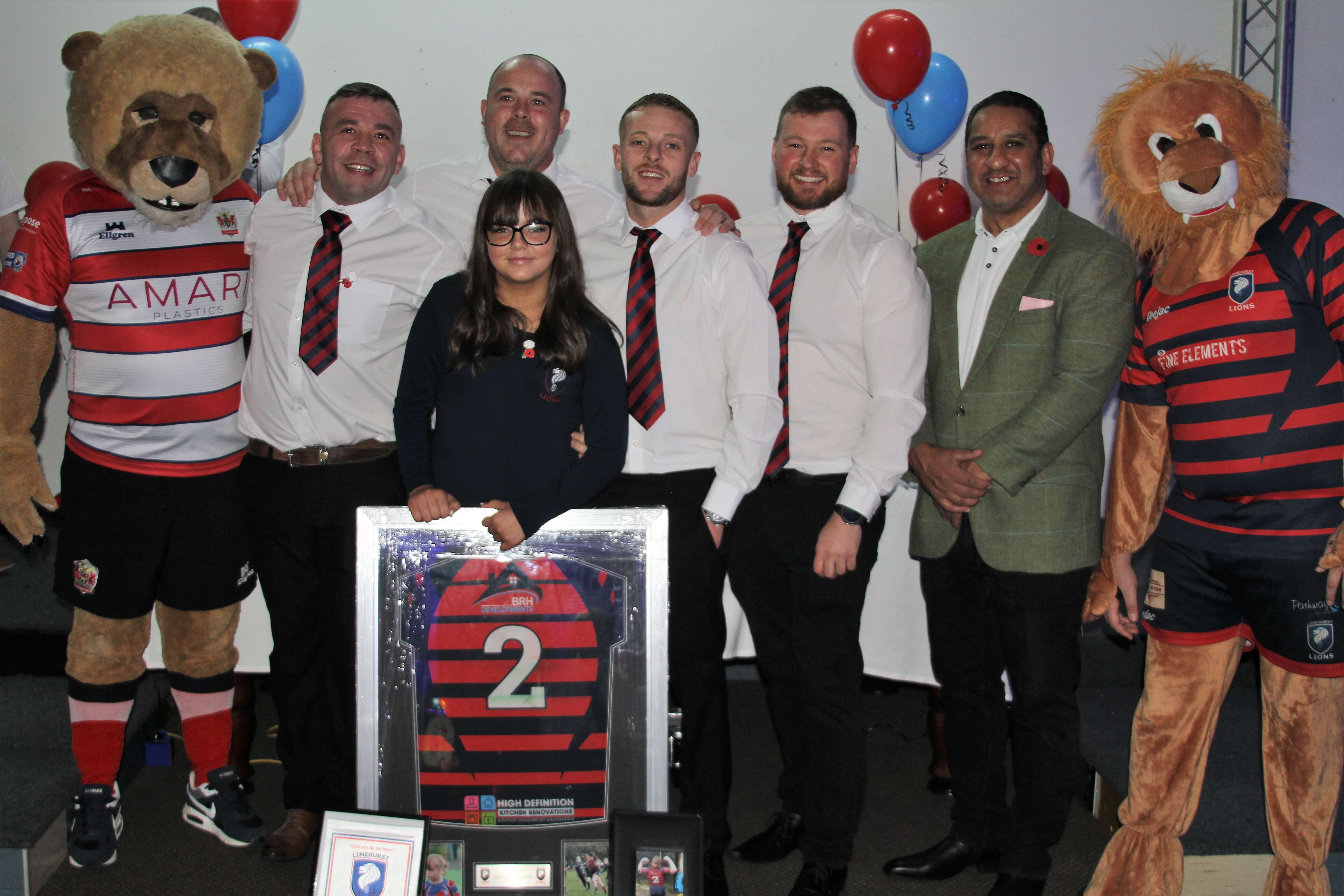 Left to right: Roary, our mascot; Limehurst coaches Lee Flaherty, Danny Martin, Wes Taylor, Bradley Lewis, Ikram Butt, Leo, Limehurst’s mascot. In front: Molly McGuirk, one for the future. Danny Martin is the grandson of the late Jack Roscoe, our timekeeper for several years.