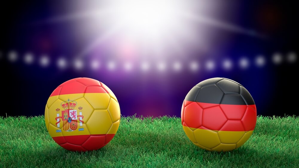 Two,Soccer,Balls,In,Flags,Colors,On,Stadium,Blurred,Background.