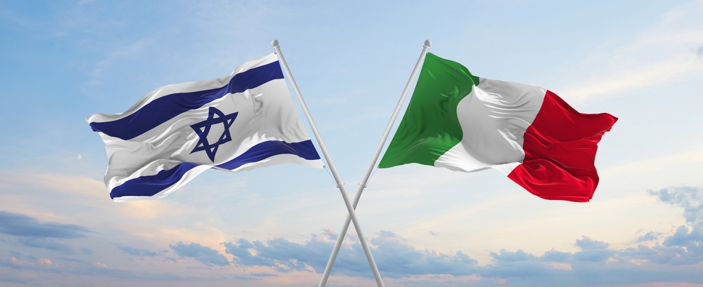 Two,Crossed,Flags,Israel,And,Italy,Waving,In,Wind,At