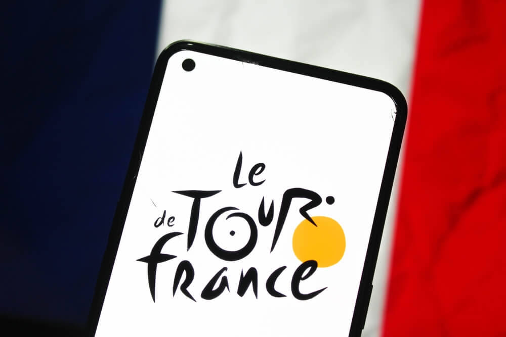 The,Tour,De,France,Logo,Is,Displayed,On,A,Mobile,Chi,Vincerà,Il,Tour,De,France,2025